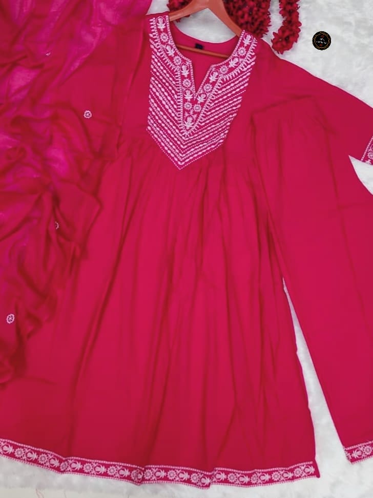 Pink dress with white embroidery on a white background